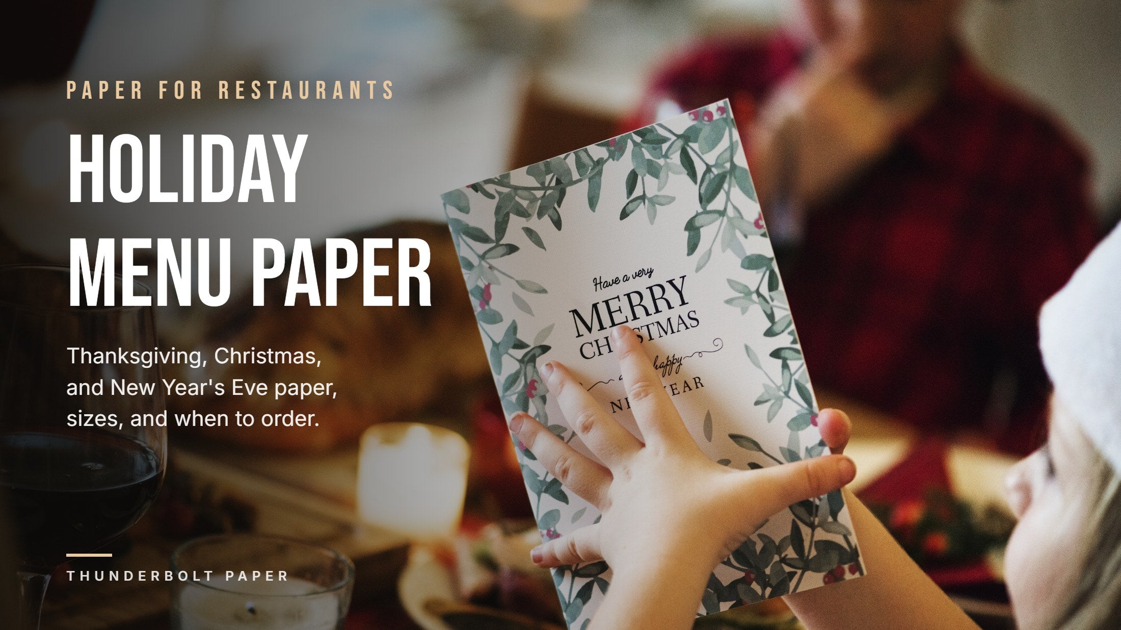 Guest holding a printed Merry Christmas menu card at a candlelit holiday dinner table