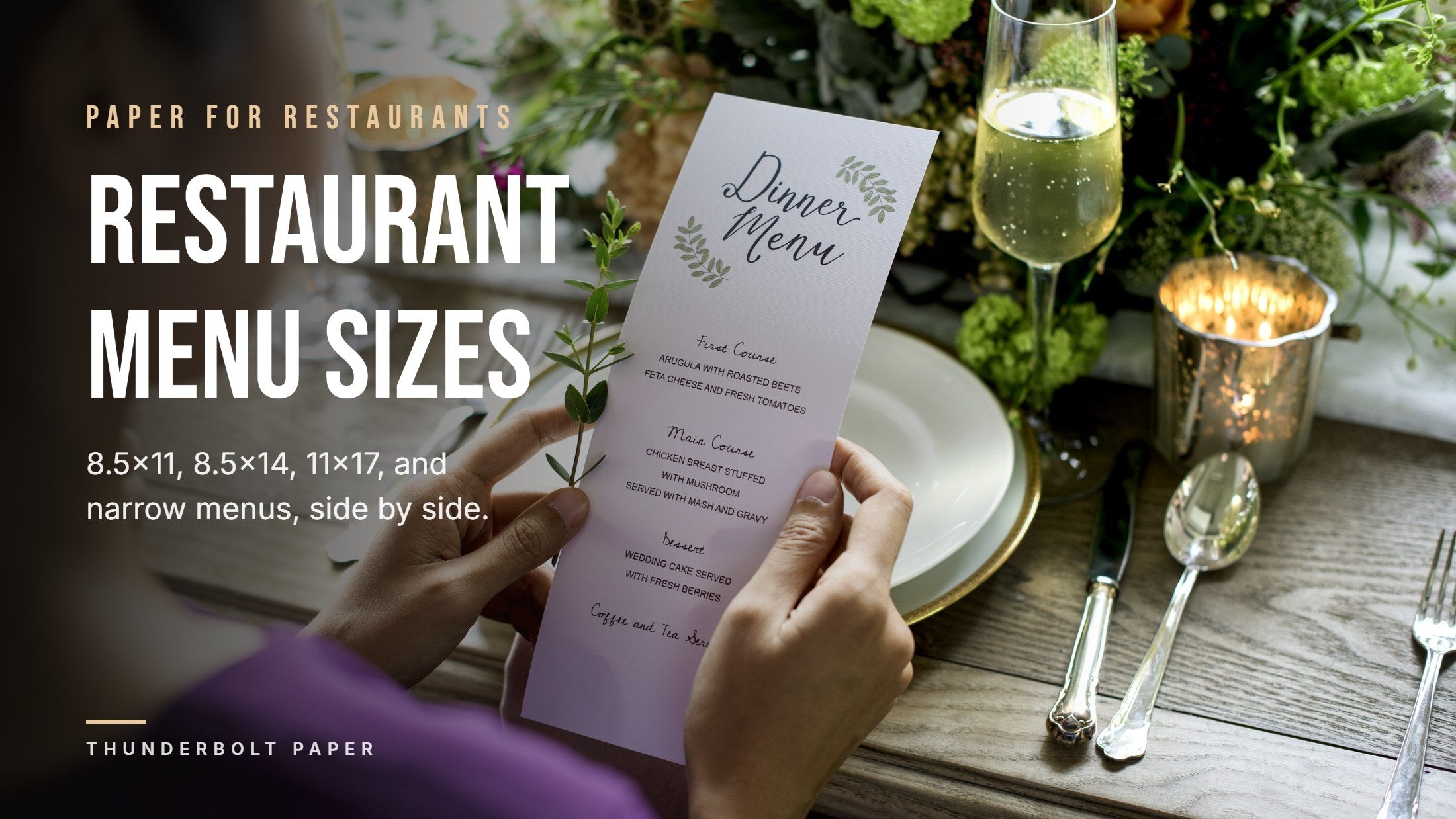 Hands holding a narrow printed dinner menu card at a set restaurant table