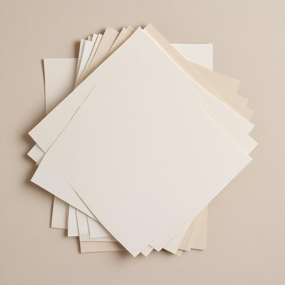 A fan of 3 x 5 paper sample cards in white, cream, and parchment tones